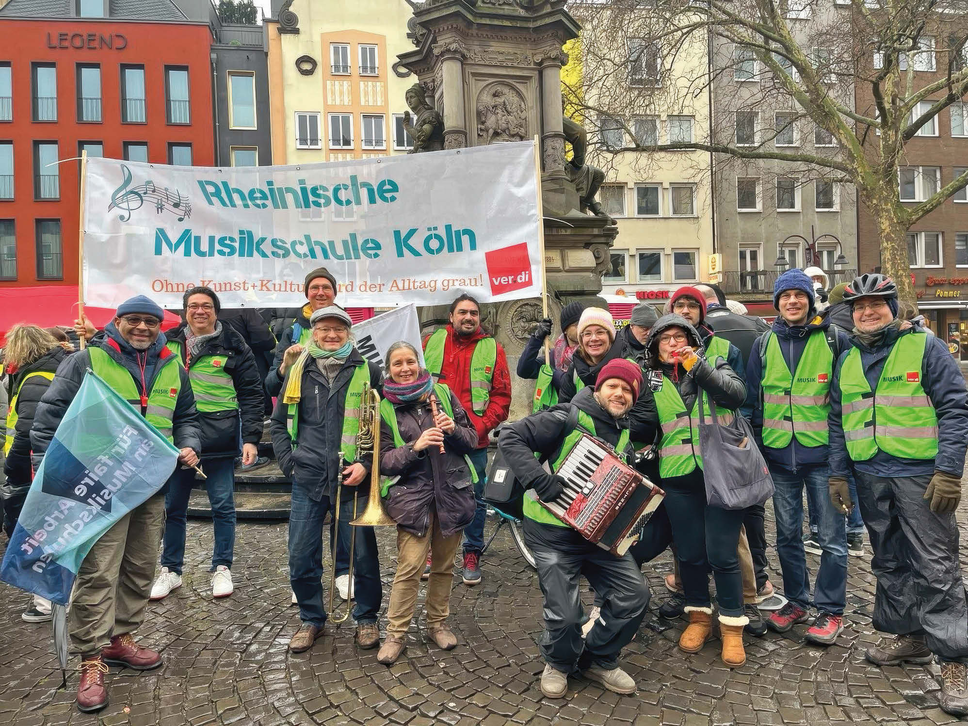 Eine Gruppe mit gelben Warnwesten und Instrumenten demonstriert.