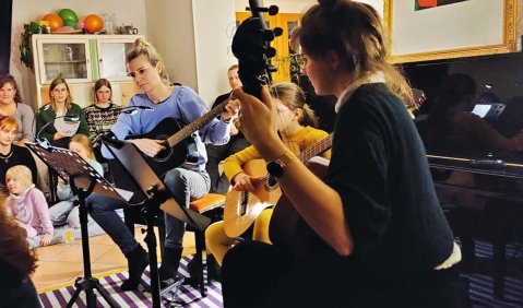 Drei Gitarisstinnen zusammen beim musizieren.